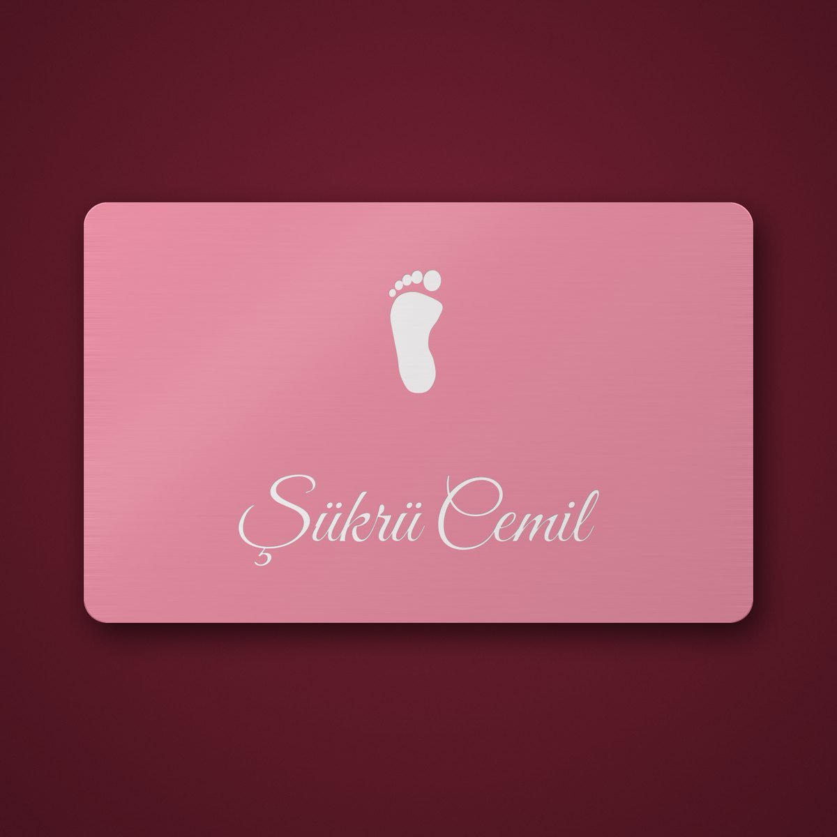FD Diamond pink anodised aluminium baby shower card, front: Şükrü Cemil, left footprint (design illustration)